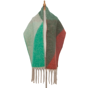 Detail of multi-color thick knit scarf showing colorful blocks and coarse tassels