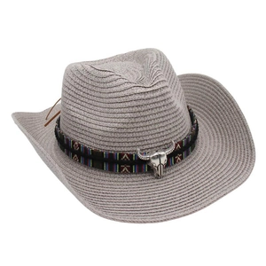Detail of grey straw cowboy hat with colorful woven band and metal bull skull ornament