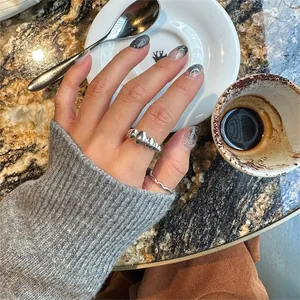Close-up of a 925 sterling silver oval beaded ring and rope band worn on a finger