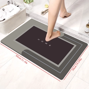 Detail of 80x50cm non-slip diatom mud bath mat with HOME text in a bathroom setting