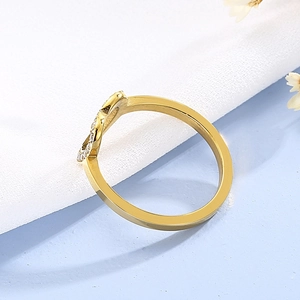 Close-up of golden heart ring with micro-pave cubic zirconia and polished finish