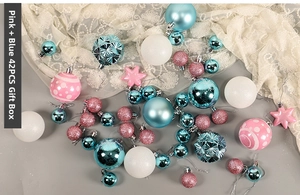 Detailed close-up of 42-piece pink and blue Christmas ball set with glitter and matte finishes