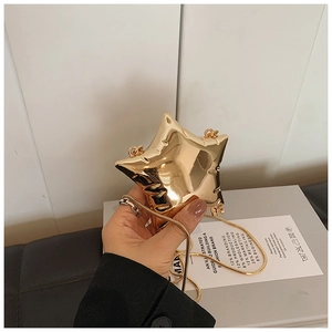 Detailed view of a gold star-shaped chain bag with metallic finish and snake bone strap
