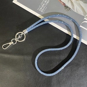 Detail view of bright blue rhinestone phone lanyard with silver swivel clasp and ring