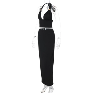 Detail of black two-piece set featuring backless halter top and slim fit maxi skirt