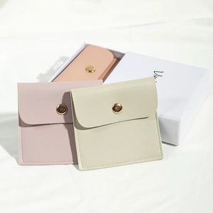 Detail of pink and beige matte PU leather jewelry pouches with golden metal snap button
