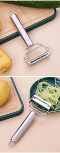 Dual stainless steel peeler and julienne slicer showing cucumber shredding process