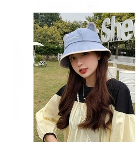 Detail view of light blue cotton bucket hat with cat ear accents and whisker embroidery