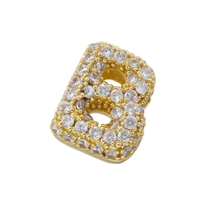 Macro shot of gold plated letter B charm paved with sparkling cubic zirconia stones