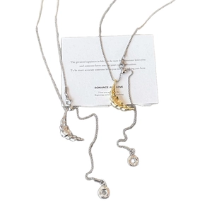 Gold and silver crescent moon necklaces with textured metal design on white card