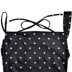 Close-up of black and white polka dot swimsuit with adjustable thin back ties