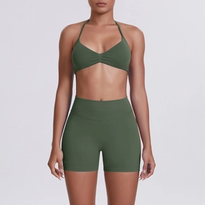 Detail of olive green halter sports bra with ruched chest and high waist yoga shorts