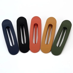 Detailed view of 5-piece matte finish oval hollow hair clips in assorted earth tones