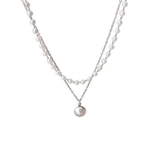 Detail of double-layer necklace featuring a pearl strand and a single pearl pendant