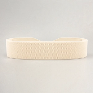 Close-up of beige elastic corset belt showing woven texture and stitched ends for dresses