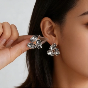 Irregular silver alloy jewelry set with gray crystal stones shown on female model