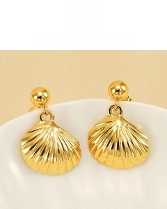 Detailed macro view of 18K gold plated shell earrings with textured metallic surface