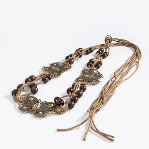 Detail of woven belt with wooden beads and bronze butterfly rhinestones bohemian style