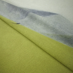 Close-up of bohemian wall tapestry showing soft flannel texture and green grey colors
