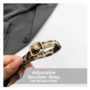Close-up of adjustable leopard print bag strap with high-quality gold metal buckle
