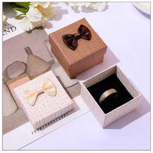 Detail of square jewelry gift boxes with bow tie decor and sponge insert for rings