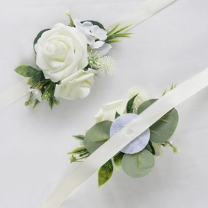 Elegant white rose wrist corsage with silk ribbon for bridal and wedding parties