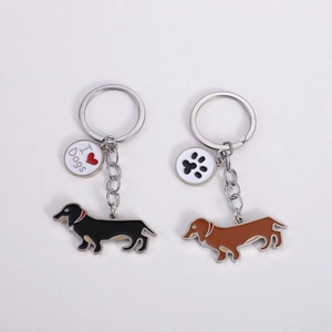 Detail of metal enamel dachshund keychains with I Heart Dogs and paw print charms