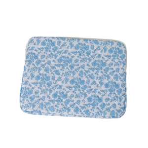 Quilted floral laptop sleeve with blue flower pattern and secure zipper closure