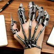 Detail of vintage silver finger armor with black gems on a dark wooden desk