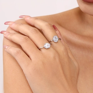 Silver rings with oval cubic zirconia stones worn on hand for wedding jewelry styling