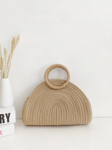 Minimalist hand-woven semi-circle tote bag in khaki cotton rope on a white surface
