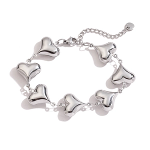Detailed close-up of silver stainless steel bracelet featuring seven 3D heart pendants