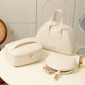 Three-piece cream PU woven cosmetic bag set including tote and travel pouches