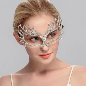 Close-up of luxury silver rhinestone party mask with sparkling flame-shaped crystal details