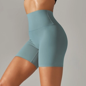 Detail of high-waisted yoga shorts in blue showing seamless side design and fit