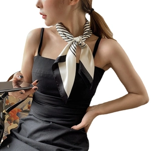 Elegant black and white striped silk scarf tied in a stylish bow knot for women