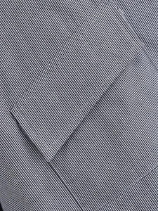 Detailed macro view of black and white plaid fabric texture and pocket stitching