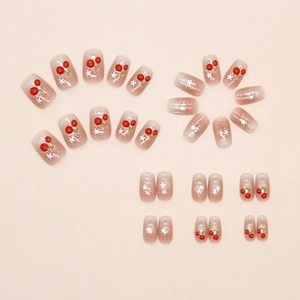 Detailed view of press-on nails featuring 3D cherry accents, silver stars, and pink glitter