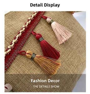 Detail of jute handbag featuring colorful bohemian tassels and woven ribbon trim