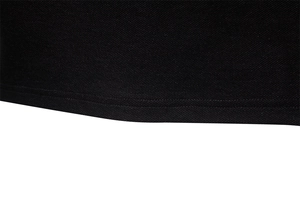 Detailed macro view of black pique cotton fabric and high-quality double-needle hem stitching