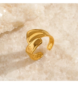 Macro shot of 18K gold plated irregular wavy open ring on natural white crystal stones