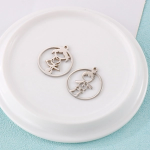 Close-up of polished silver stainless steel boy and girl hollow round pendants with rings