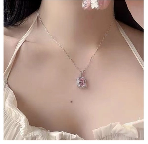 Close-up of S925 silver necklace featuring a pink square crystal pendant worn by a model