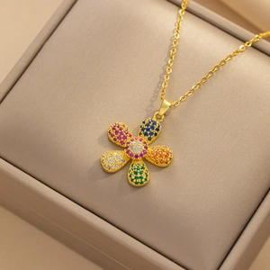 Golden necklace with colorful sunflower gemstone pendant in a beige jewelry gift box