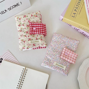 Detail of floral fabric book covers with cute ribbon ties and quilted cotton texture