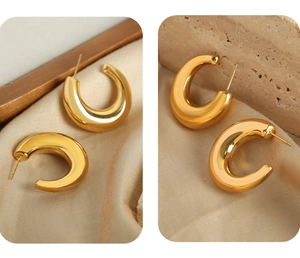 Detailed view of polished gold-plated stainless steel thick C-shaped hoop earrings