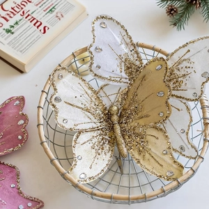 Sparkly butterfly Christmas ornaments with gold glitter and rhinestones in rustic basket