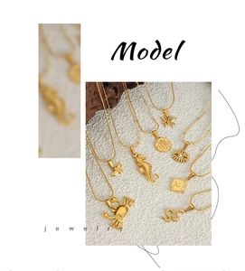 Detailed display of gold layered necklaces with crab, seahorse, and bee charms