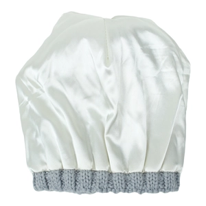 Detailed view of silky white satin sleep cap with grey elastic knit band texture