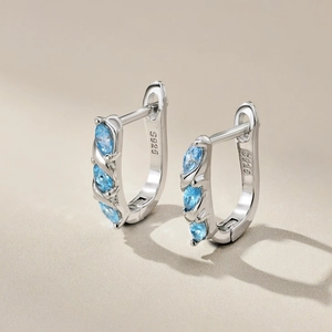 Macro shot of S925 sterling silver earrings featuring blue marquise-cut zircon stones